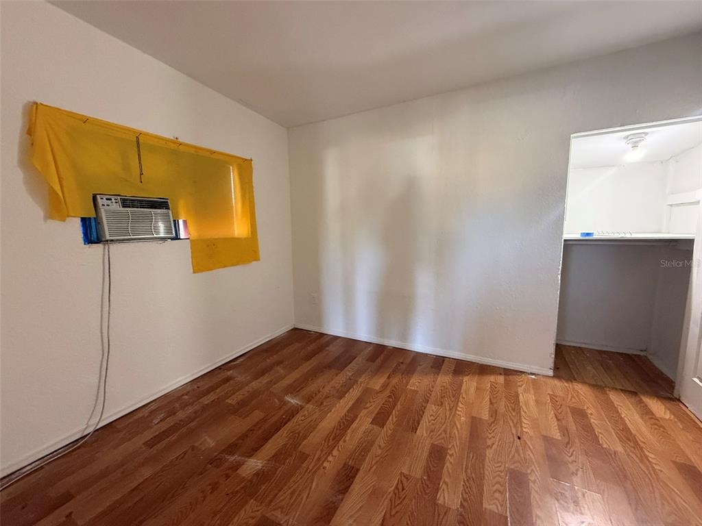 9013 Burr Drive Polk City, FL 33868 - Photo 6 of 20 a view of an empty room with wooden floor