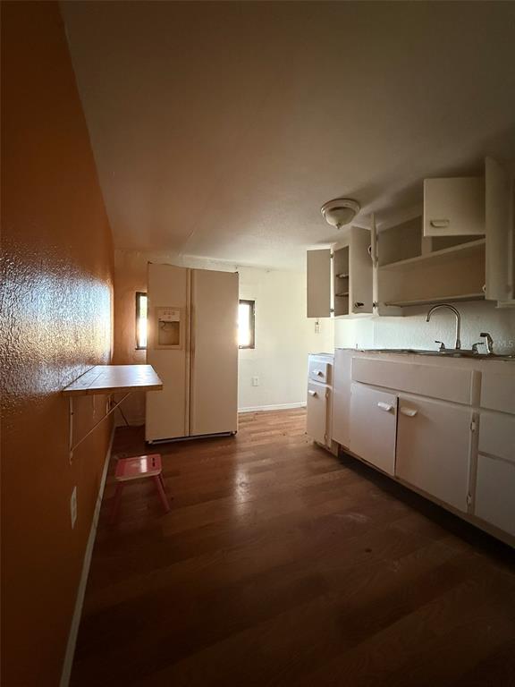 9013 Burr Drive Polk City, FL 33868 - Photo 9 of 20 a kitchen with cabinets and wooden floor