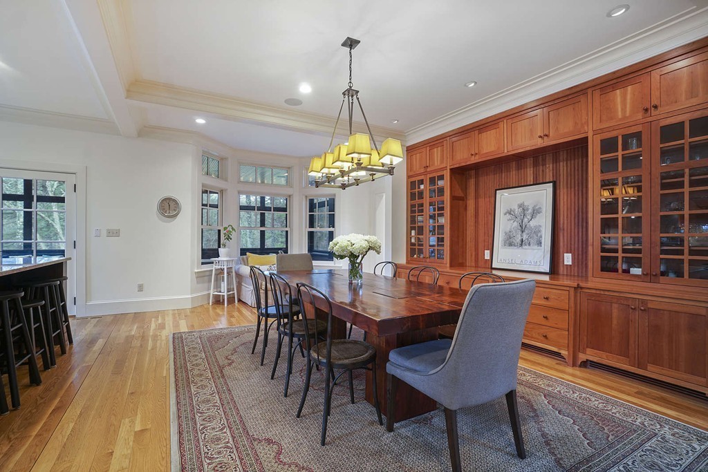 111 Tower Road Lincoln, MA 01773 - Photo 11 of 30 a dining room with wooden floor a chandelier a wooden table and chairs