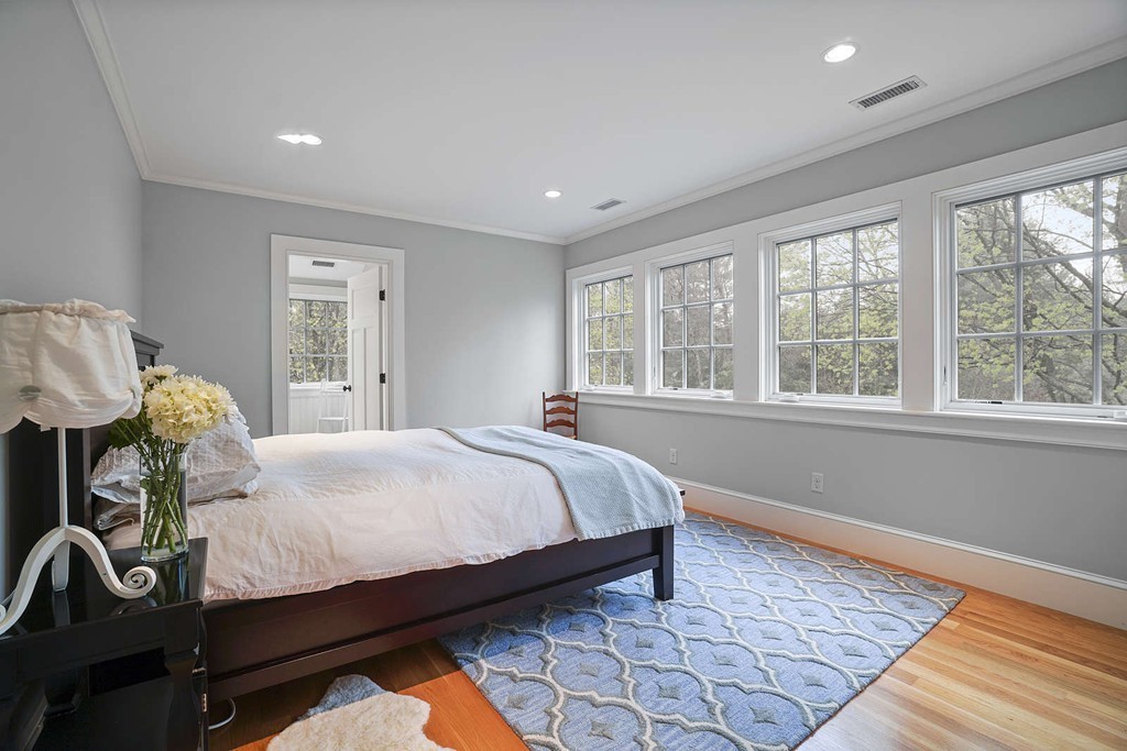 111 Tower Road Lincoln, MA 01773 - Photo 28 of 30 a bedroom with a bed and wooden floor