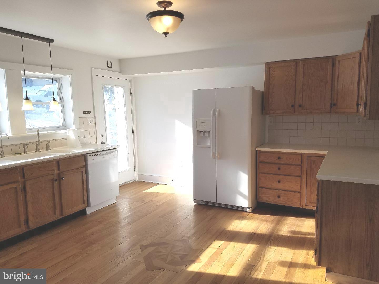 4087 Highway 202, Unit B Doylestown, PA 18902 - Photo 4 of 16 a view of a kitchen with wooden cabinet and a large window