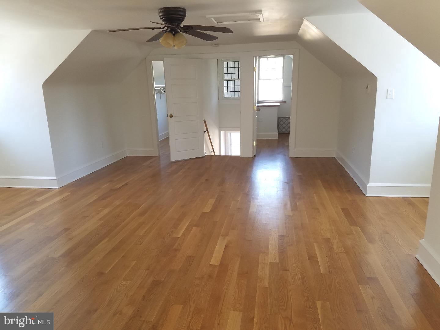 4087 Highway 202, Unit B Doylestown, PA 18902 - Photo 8 of 16 a view of a livingroom with wooden floor and a ceiling fan