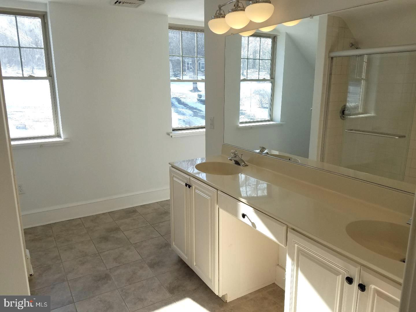 4087 Highway 202, Unit B Doylestown, PA 18902 - Photo 10 of 16 a bathroom with a double vanity sink and a mirror