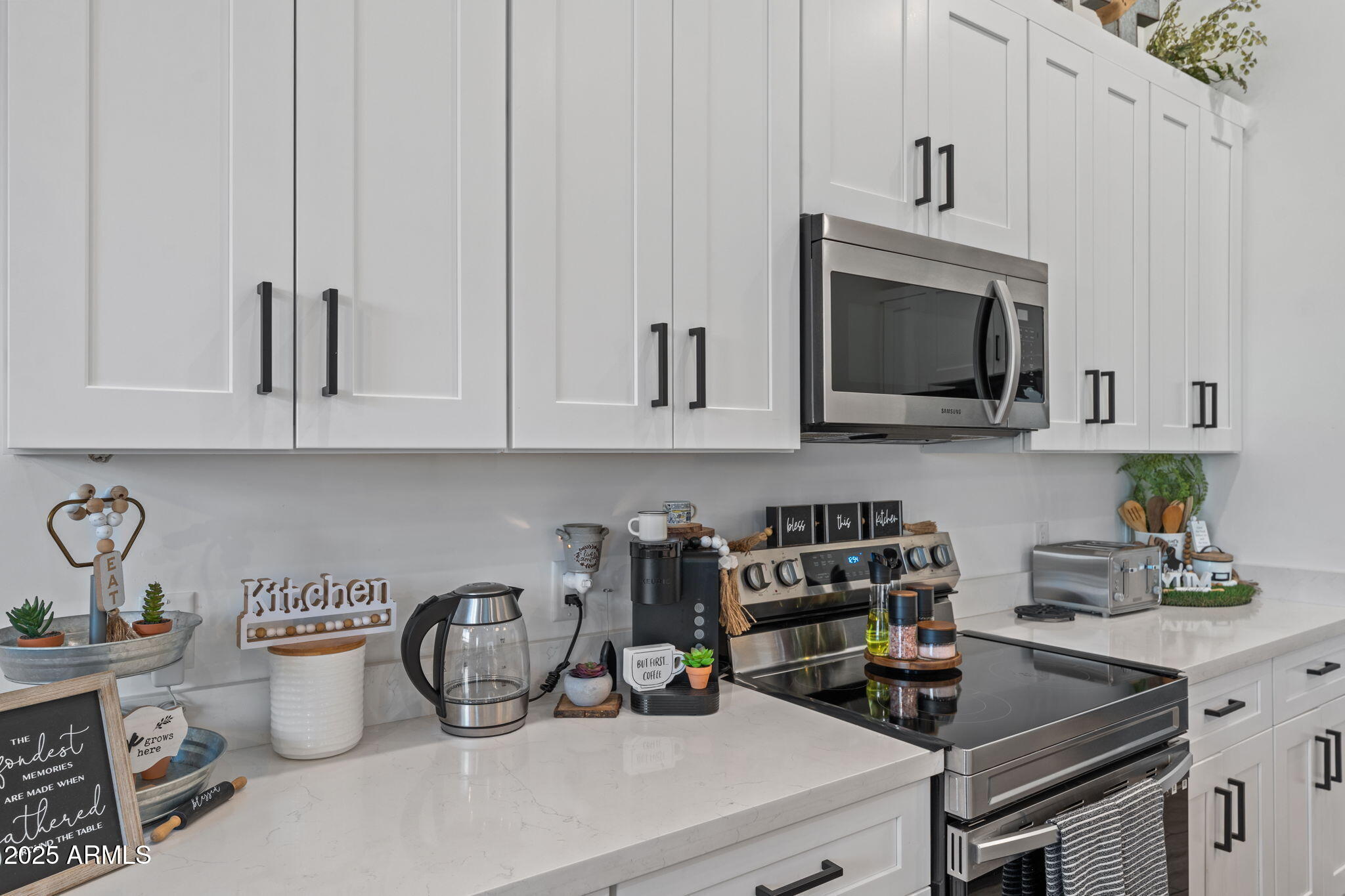 10534 East Butte Street Apache Junction, AZ 85120 - Photo 13 of 51 a kitchen with a stove a microwave and cabinets