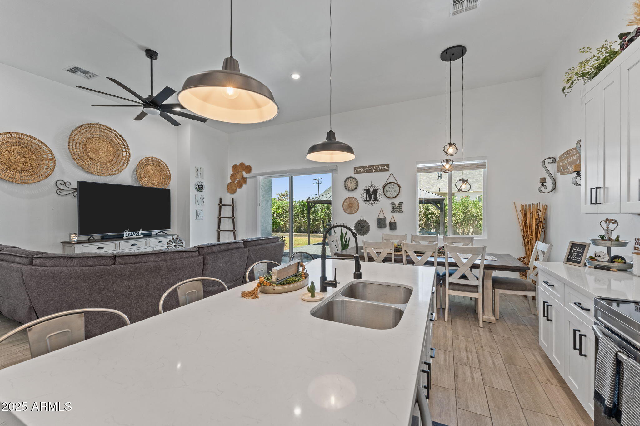 10534 East Butte Street Apache Junction, AZ 85120 - Photo 14 of 51 a kitchen with stainless steel appliances a stove a sink a dining table and chairs with wooden floor