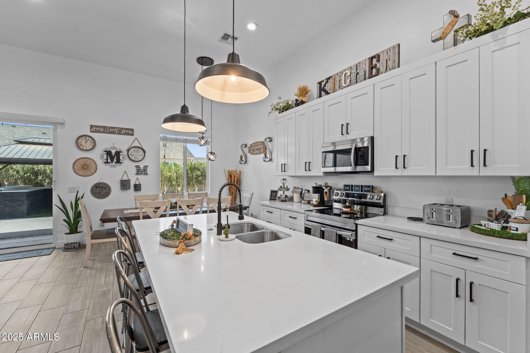 10534 East Butte Street Apache Junction, AZ 85120 - Photo 15 of 51 a kitchen with stainless steel appliances a stove a sink a microwave and cabinets