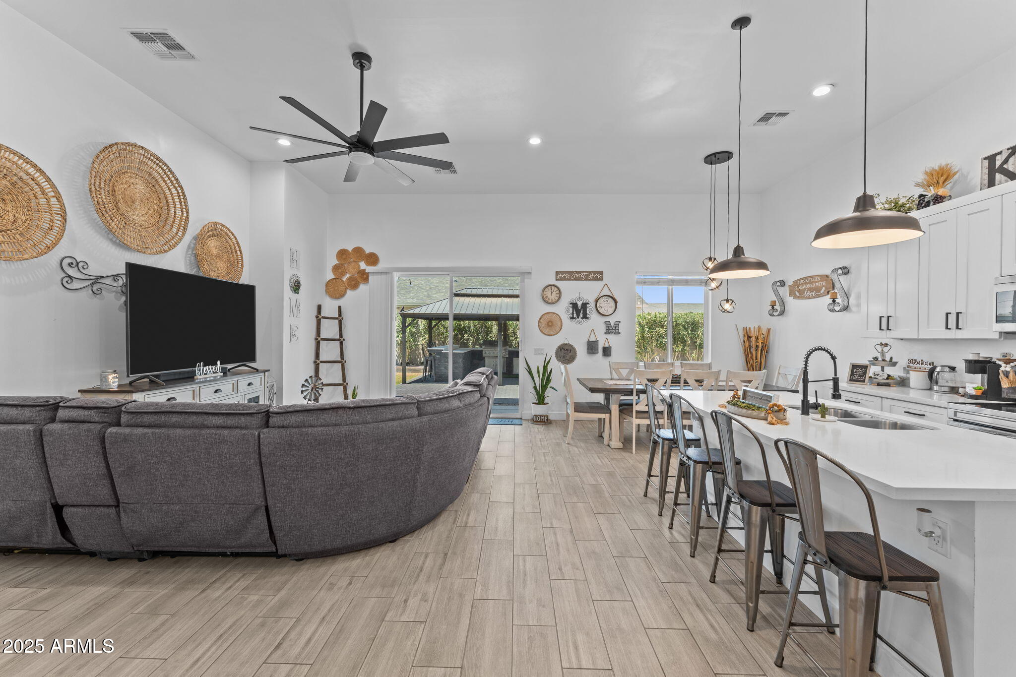 10534 East Butte Street Apache Junction, AZ 85120 - Photo 17 of 51 a living room with furniture a clock and a flat screen tv