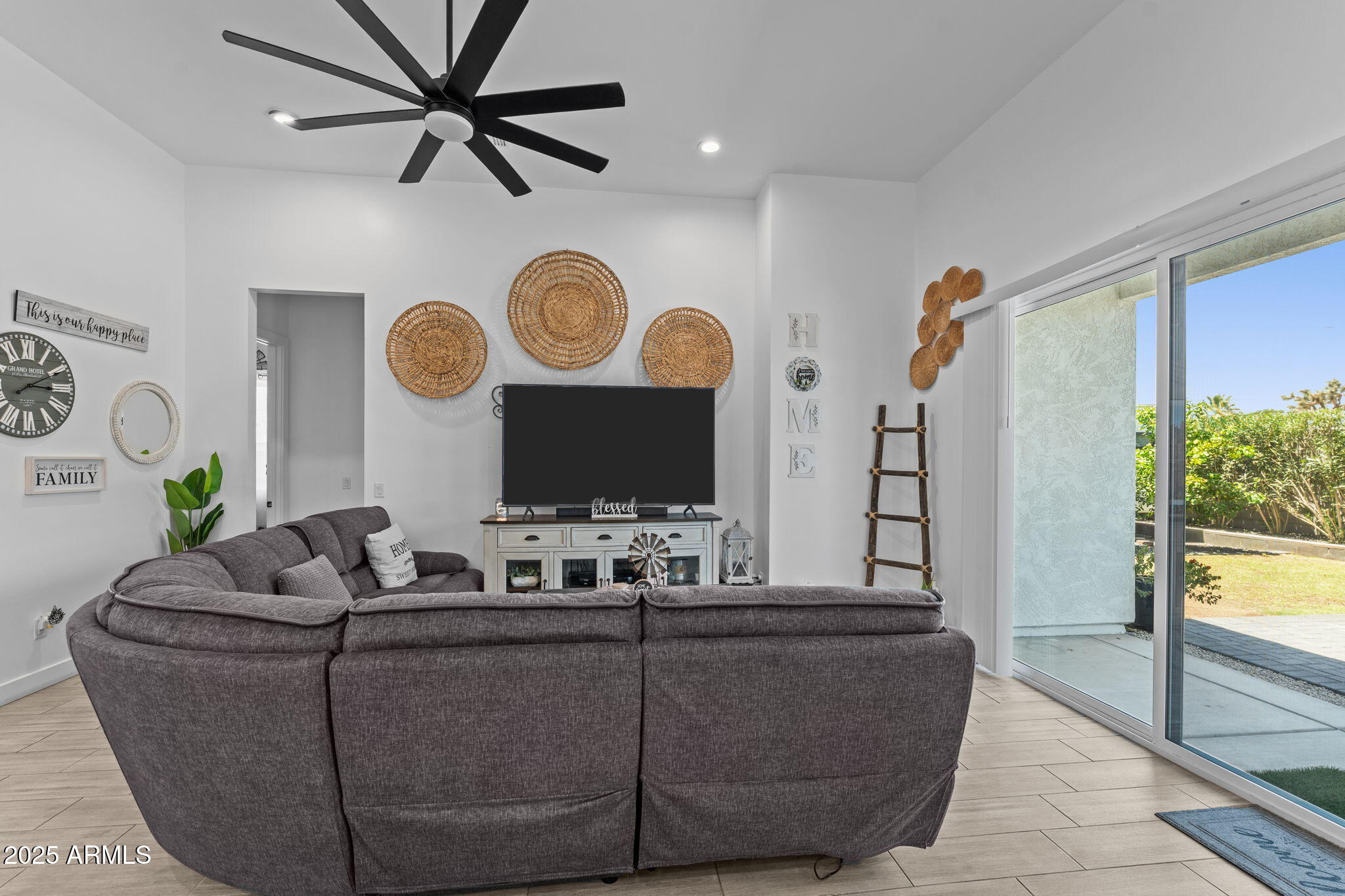 10534 East Butte Street Apache Junction, AZ 85120 - Photo 19 of 51 a living room with couches a fireplace and a large mirror with wooden floor