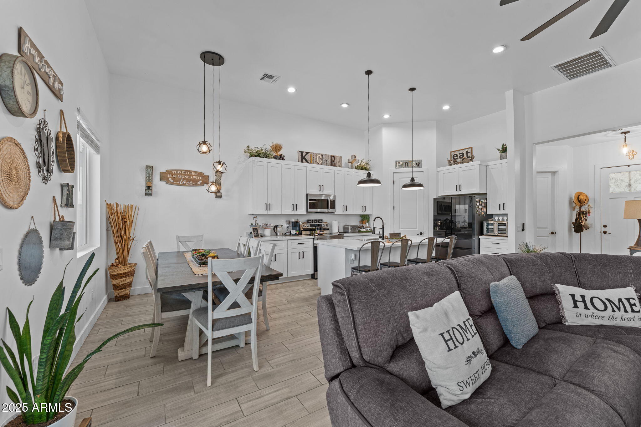 10534 East Butte Street Apache Junction, AZ 85120 - Photo 21 of 51 a living room with furniture a rug kitchen view and a chandelier
