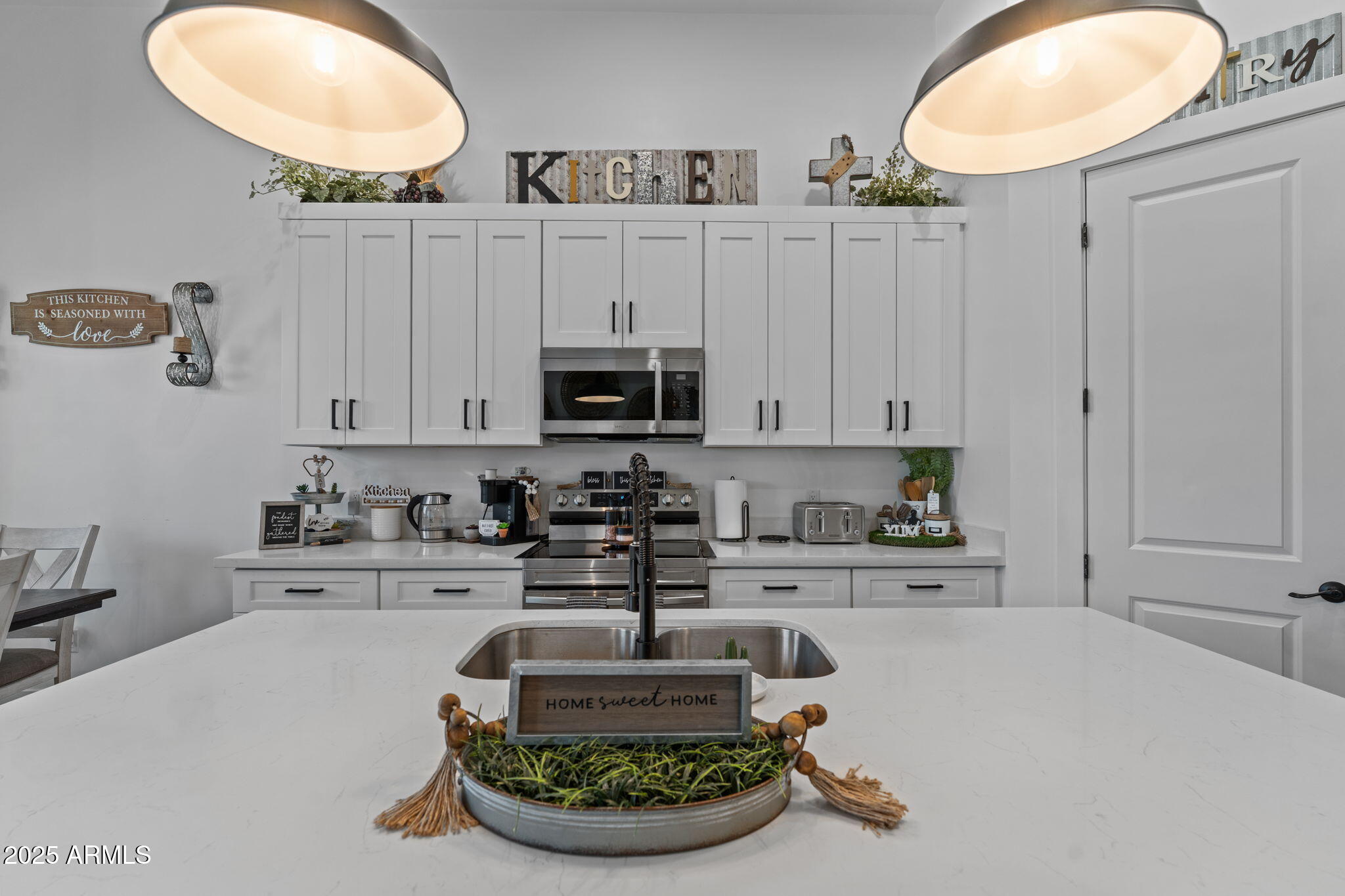 10534 East Butte Street Apache Junction, AZ 85120 - Photo 22 of 51 a kitchen with stainless steel appliances granite countertop a sink a stove and cabinets