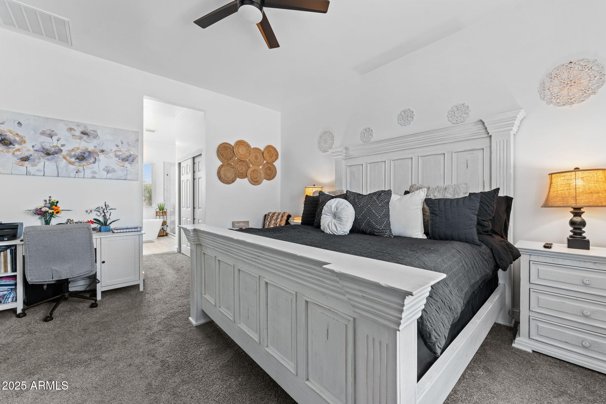 10534 East Butte Street Apache Junction, AZ 85120 - Photo 26 of 51 a spacious bedroom with a bed and a lamp