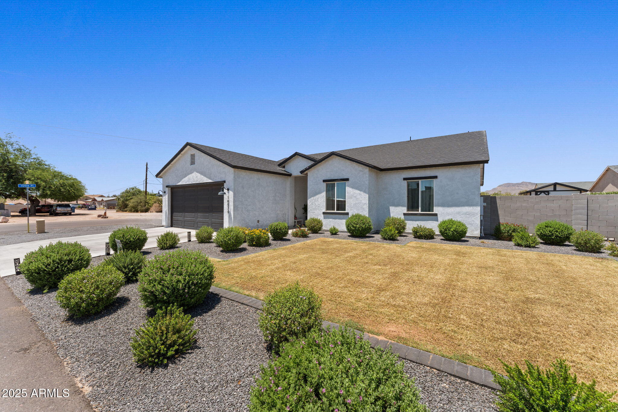 10534 East Butte Street Apache Junction, AZ 85120 - Photo 4 of 51 a front view of a house with a yard and garage