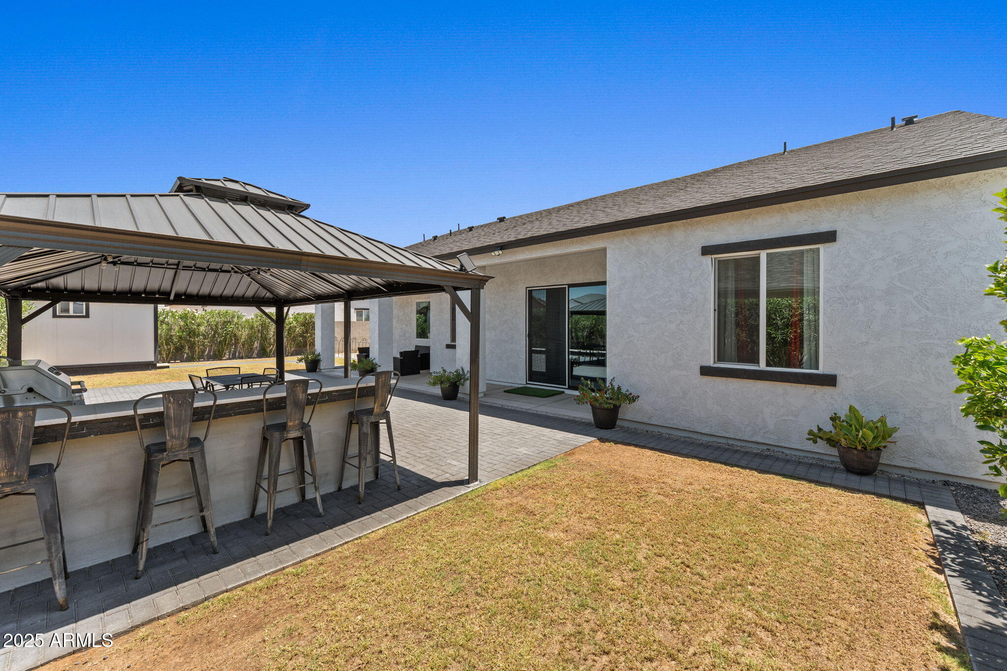 10534 East Butte Street Apache Junction, AZ 85120 - Photo 45 of 51 a patio with a table and chairs under an umbrella