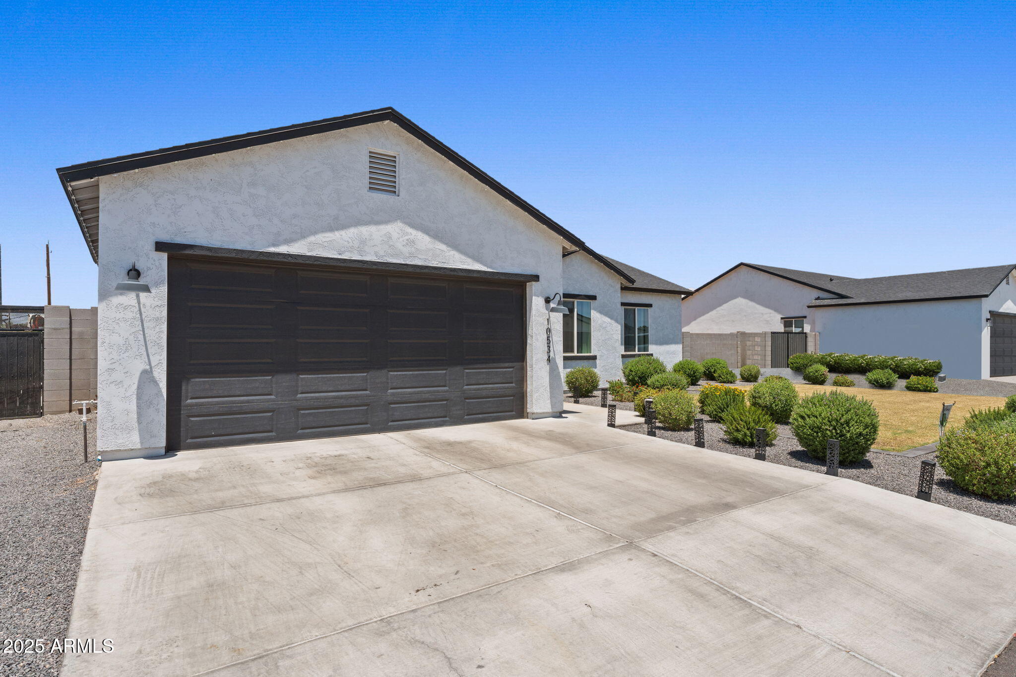 10534 East Butte Street Apache Junction, AZ 85120 - Photo 5 of 51 a front view of a house with a yard and garage