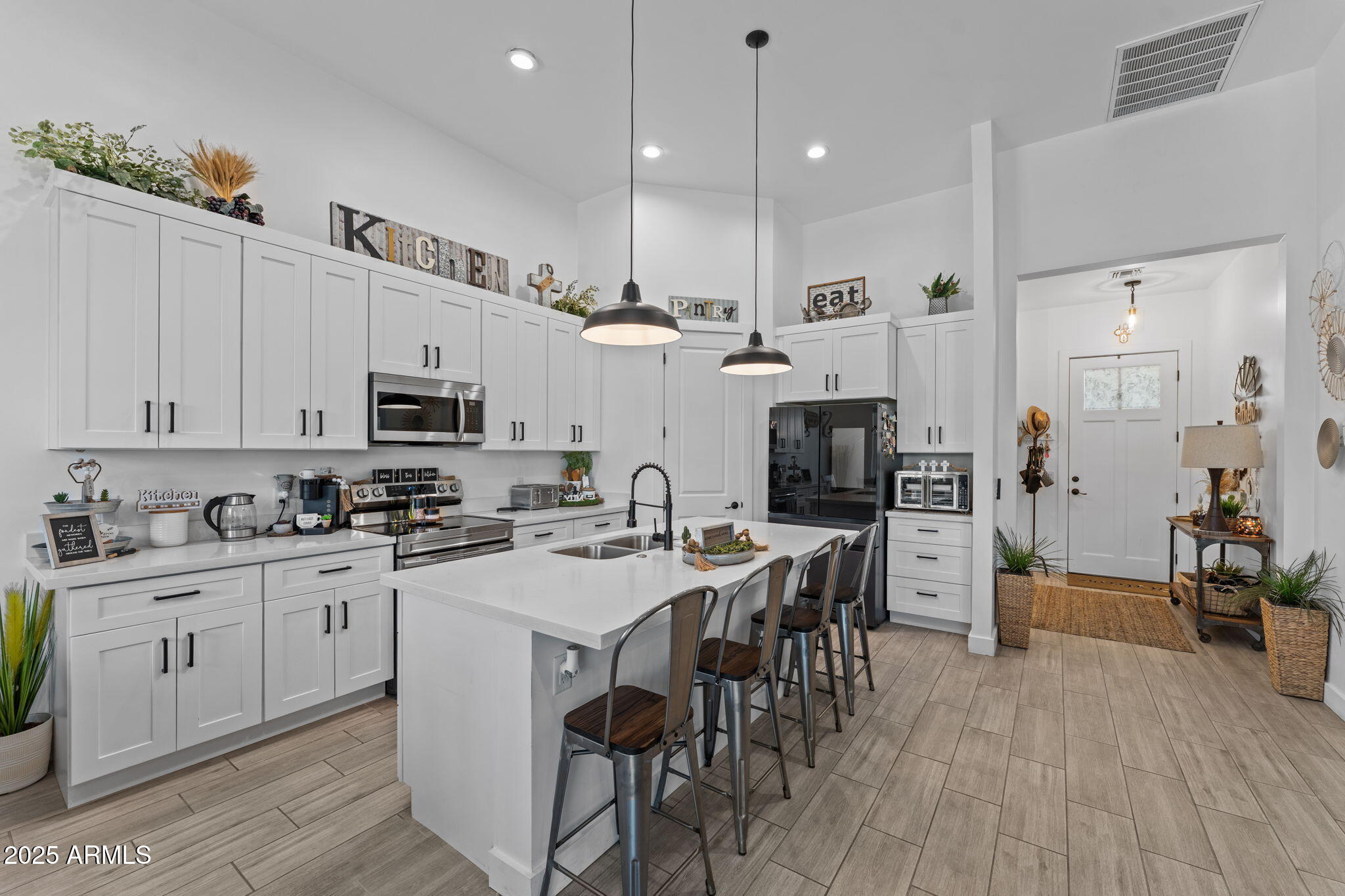 10534 East Butte Street Apache Junction, AZ 85120 - Photo 9 of 51 a kitchen with stainless steel appliances a stove a sink a microwave a center island and cabinets