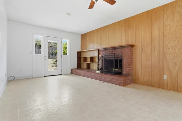 an empty room with furniture and fireplace