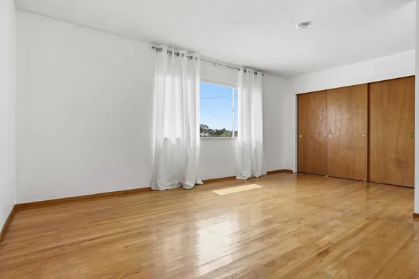 an empty room with closet area
