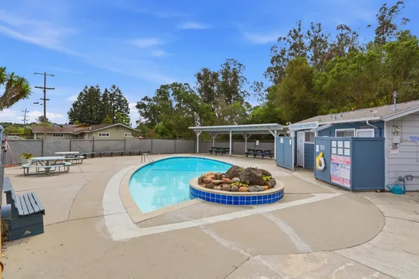 a view of a house with swimming pool and sitting area