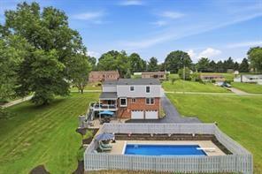 283 Brookwood Road Venetia, PA 15367 - Photo 30 of 36 a view of a swimming pool with lawn chairs and a big yard