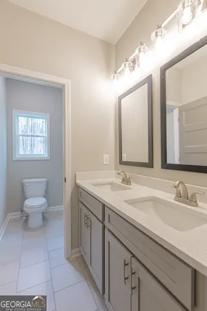 a spacious bathroom with a granite countertop sink mirror and toilet