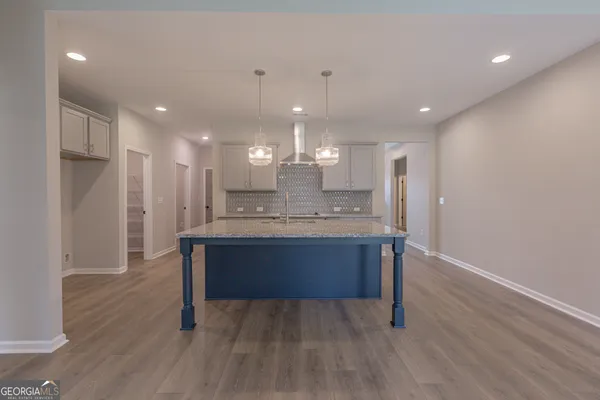 a view of kitchen with refrigerator microwave and wooden floor