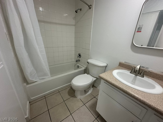 3322 South Pecos Road Las Vegas, NV 89121 - Photo 10 of 16 Tiled flooring and a classic tub shower design define this functional bathroom.