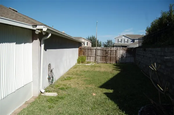 a view of a house with backyard and deck