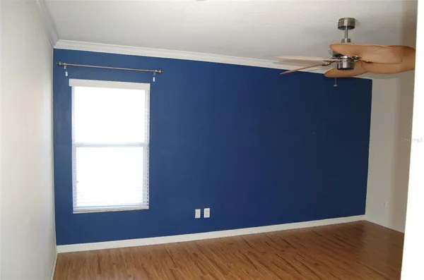 an empty room with wooden floor and closet