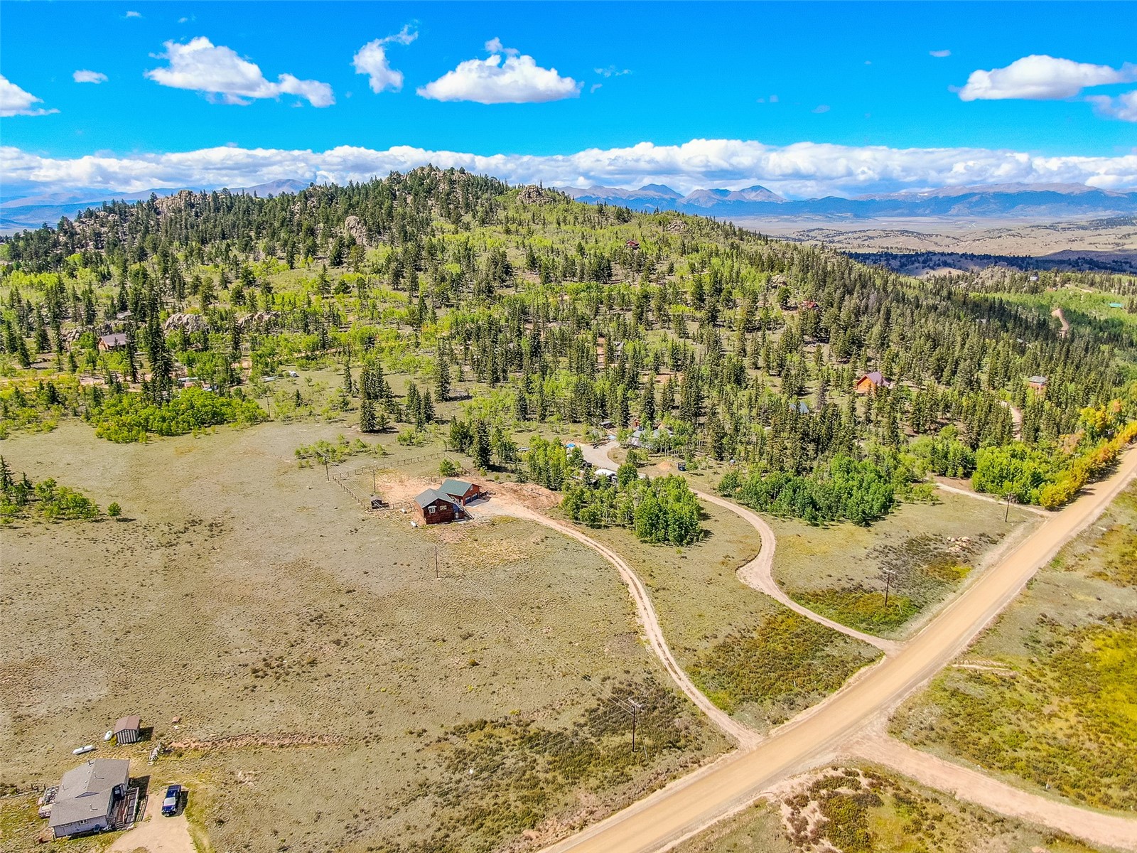 2491 Stagestop Road Jefferson, CO 80456 - Photo 40 of 43 a view of a wooden floor with a view of mountains in the background