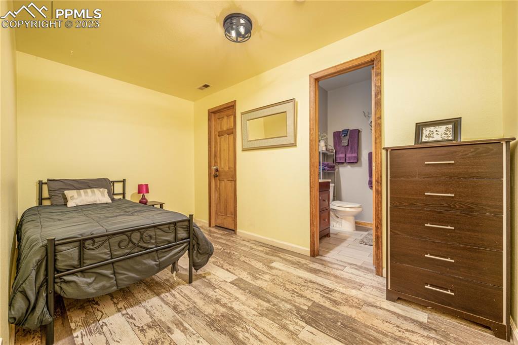 1313 Spring Valley Drive Divide, CO 80814 - Photo 11 of 25 a bedroom with a bed and a dresser