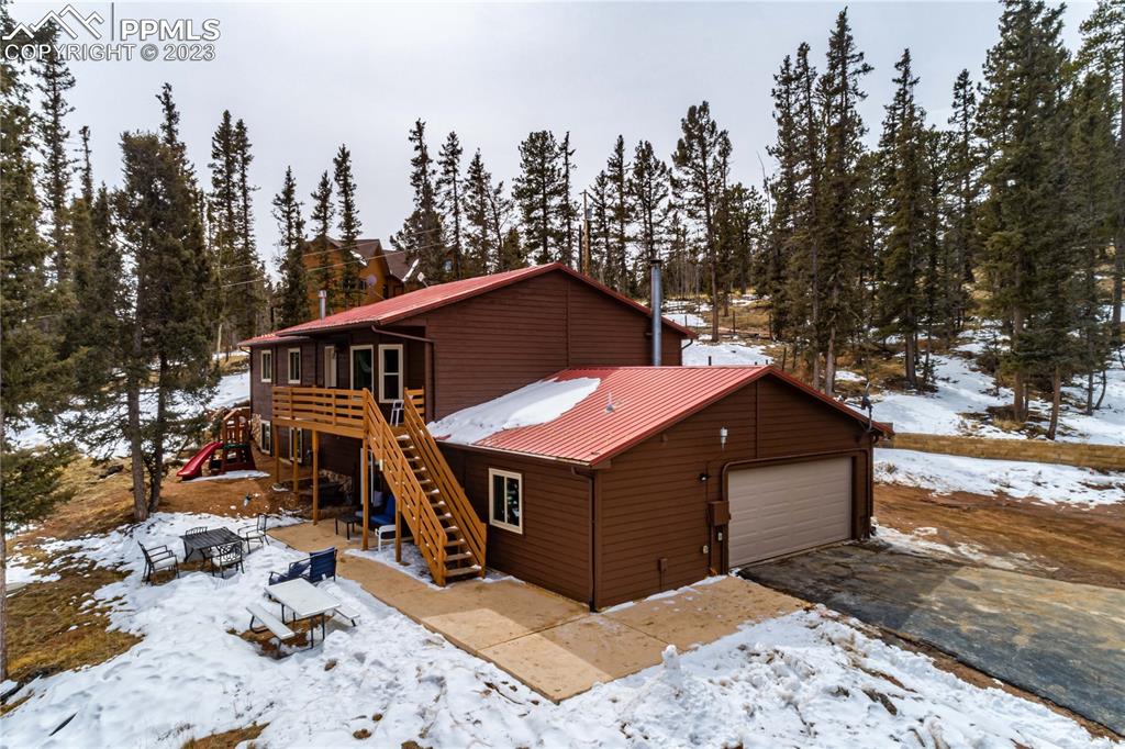1313 Spring Valley Drive Divide, CO 80814 - Photo 17 of 25 a view of a house with a yard covered in snow