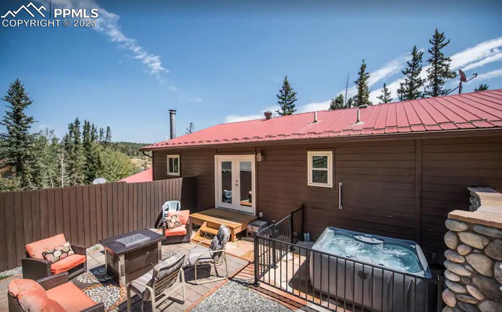 1313 Spring Valley Drive Divide, CO 80814 - Photo 18 of 25 a view of a patio with table and chairs with wooden fence