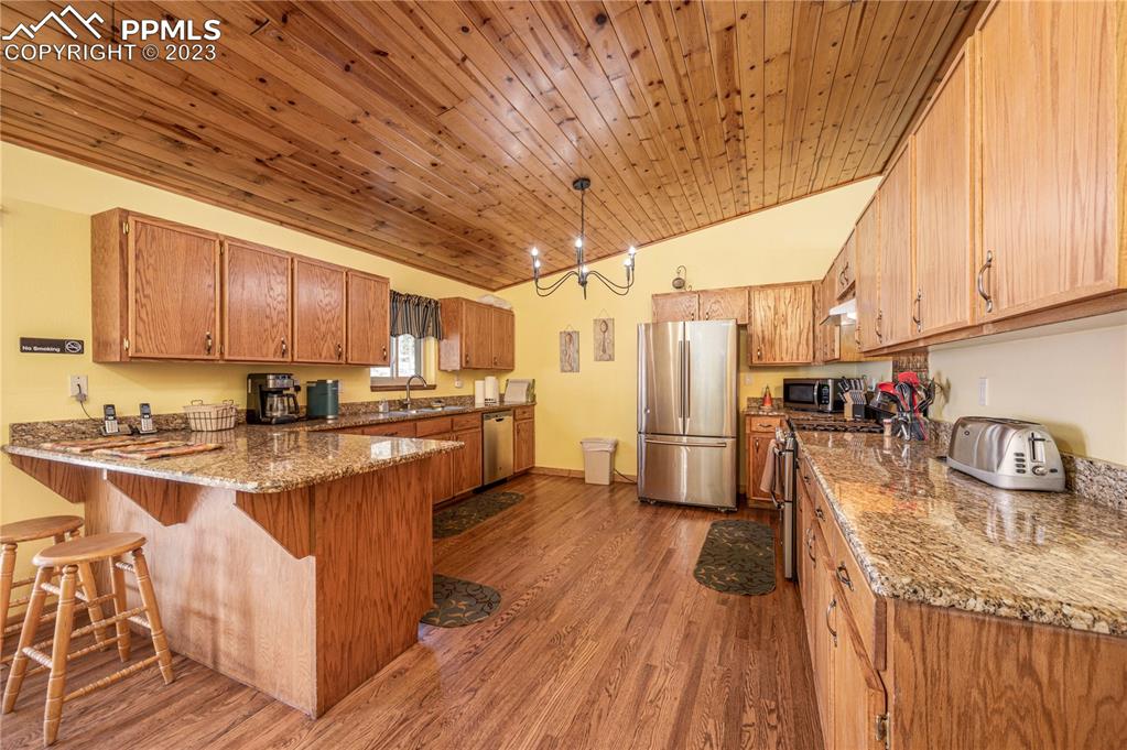 1313 Spring Valley Drive Divide, CO 80814 - Photo 6 of 25 a kitchen with refrigerator and cabinets