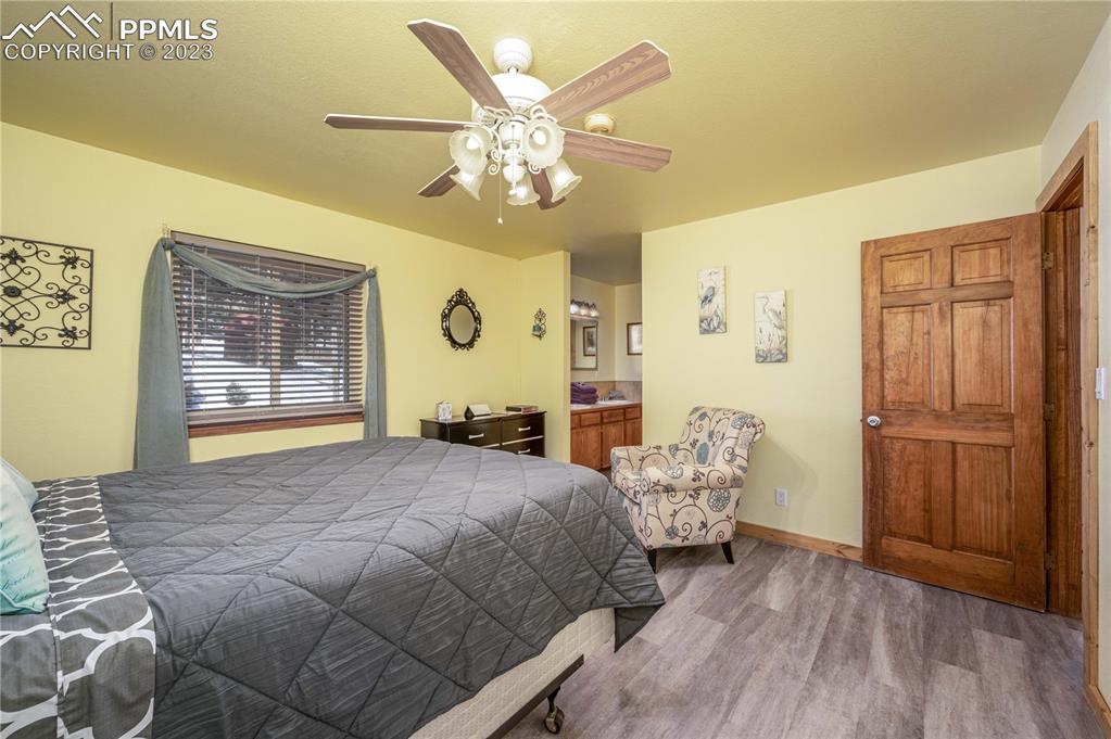 1313 Spring Valley Drive Divide, CO 80814 - Photo 7 of 25 a bedroom with a bed chandelier and a window