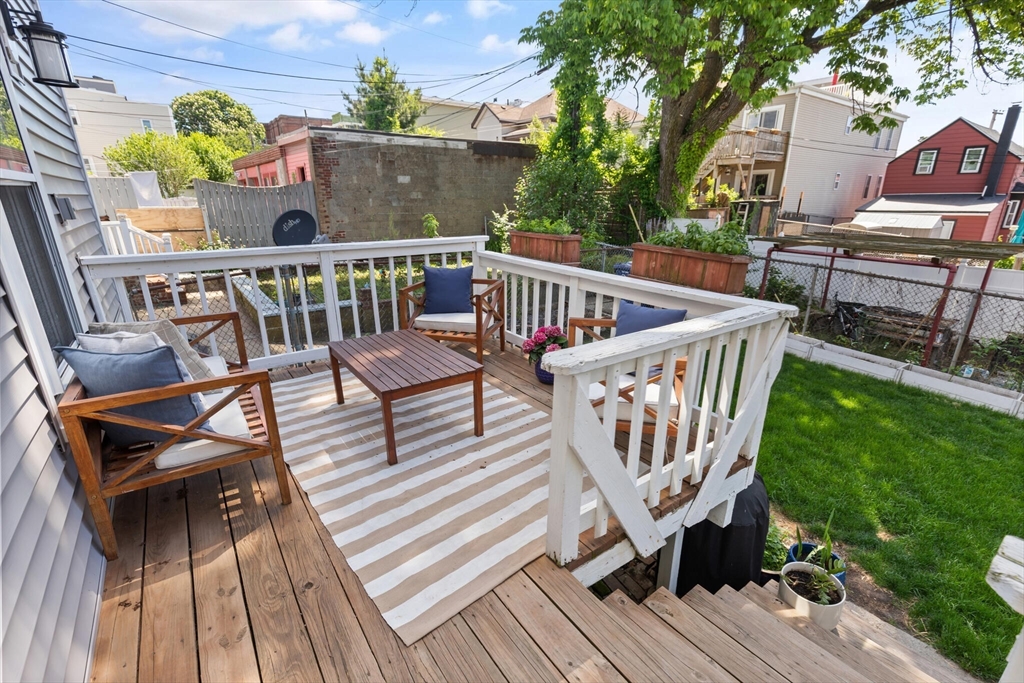 573 Bennington Street, Unit 2 Boston, MA 02128 - Photo 20 of 22 a view of balcony with wooden floor outdoor seating and yard in the back