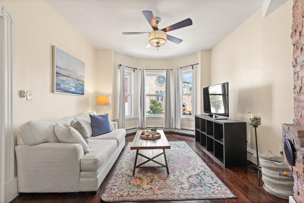 573 Bennington Street, Unit 2 Boston, MA 02128 - Photo 4 of 22 a living room with furniture a rug and a flat screen tv