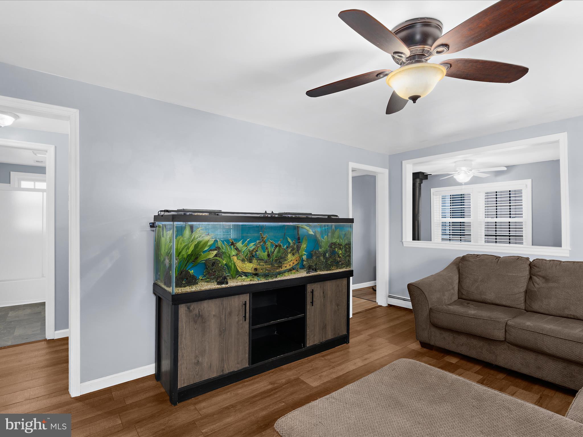 5521 Patrick Henry Drive Baltimore, MD 21225 - Photo 3 of 33 a living room with furniture a ceiling fan and a window