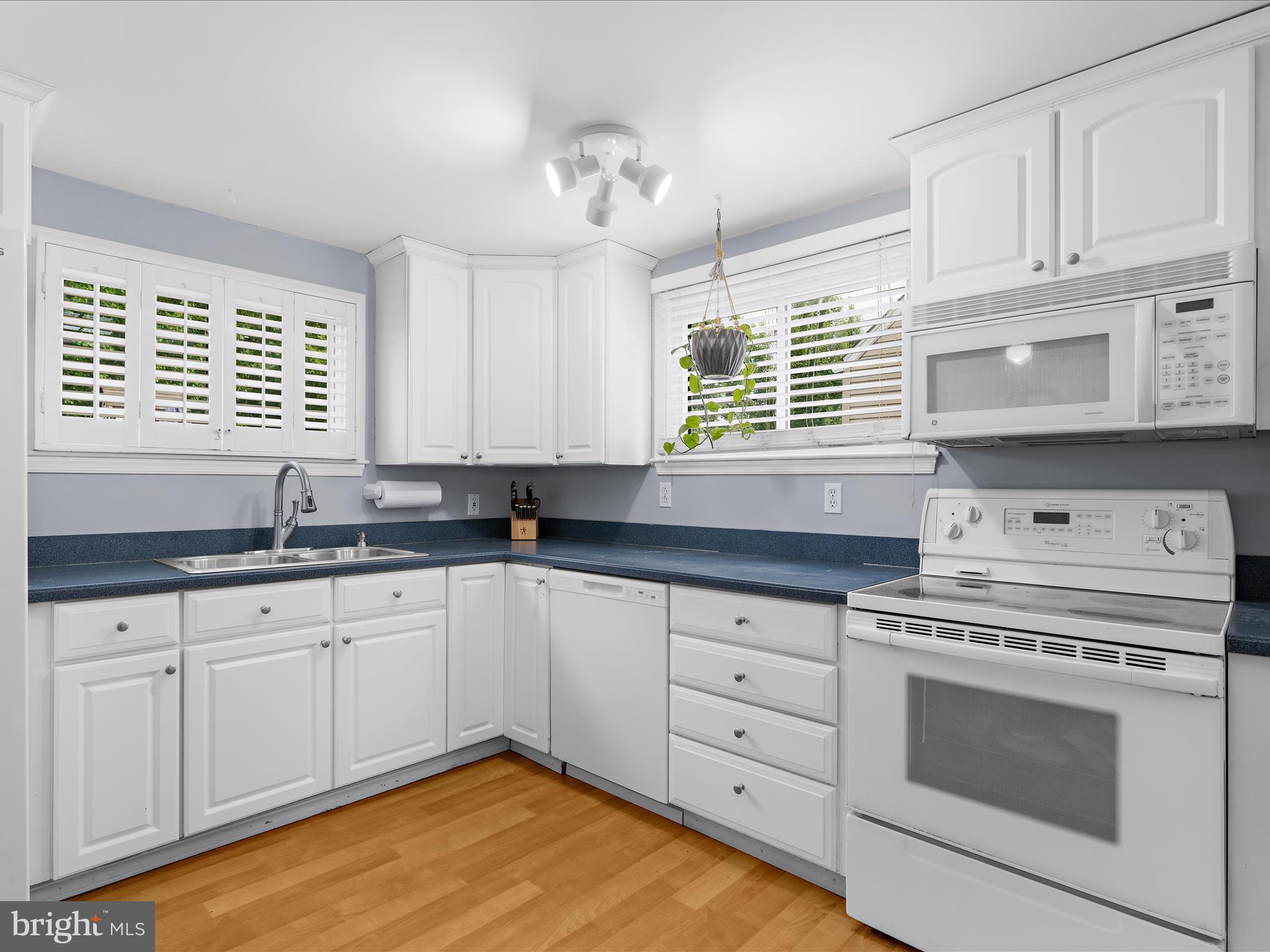 5521 Patrick Henry Drive Baltimore, MD 21225 - Photo 5 of 33 a kitchen with granite countertop white cabinets and window