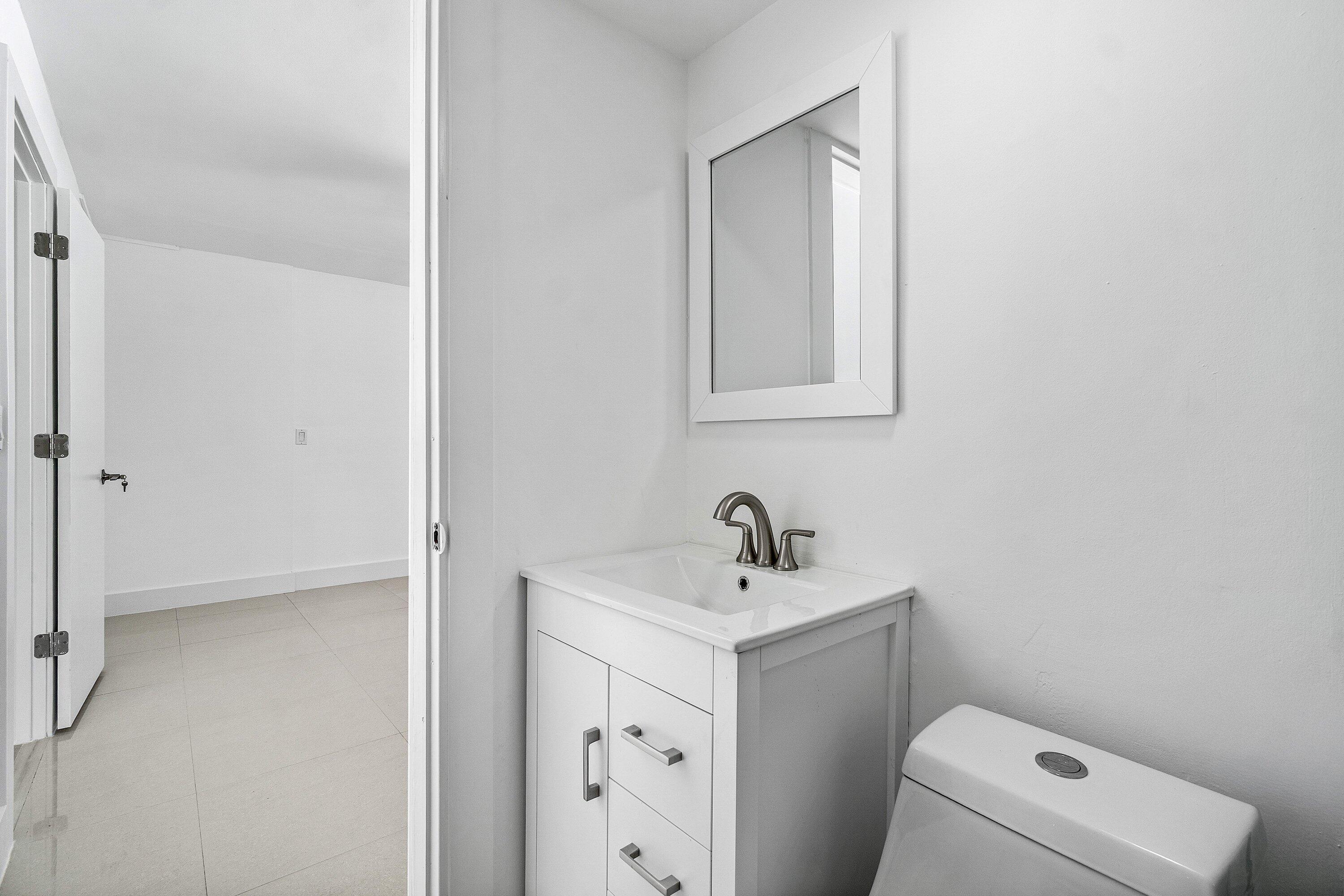 1531 Northwest 4th Street Boca Raton, FL 33486 - Photo 20 of 34 a bathroom with a toilet sink and mirror