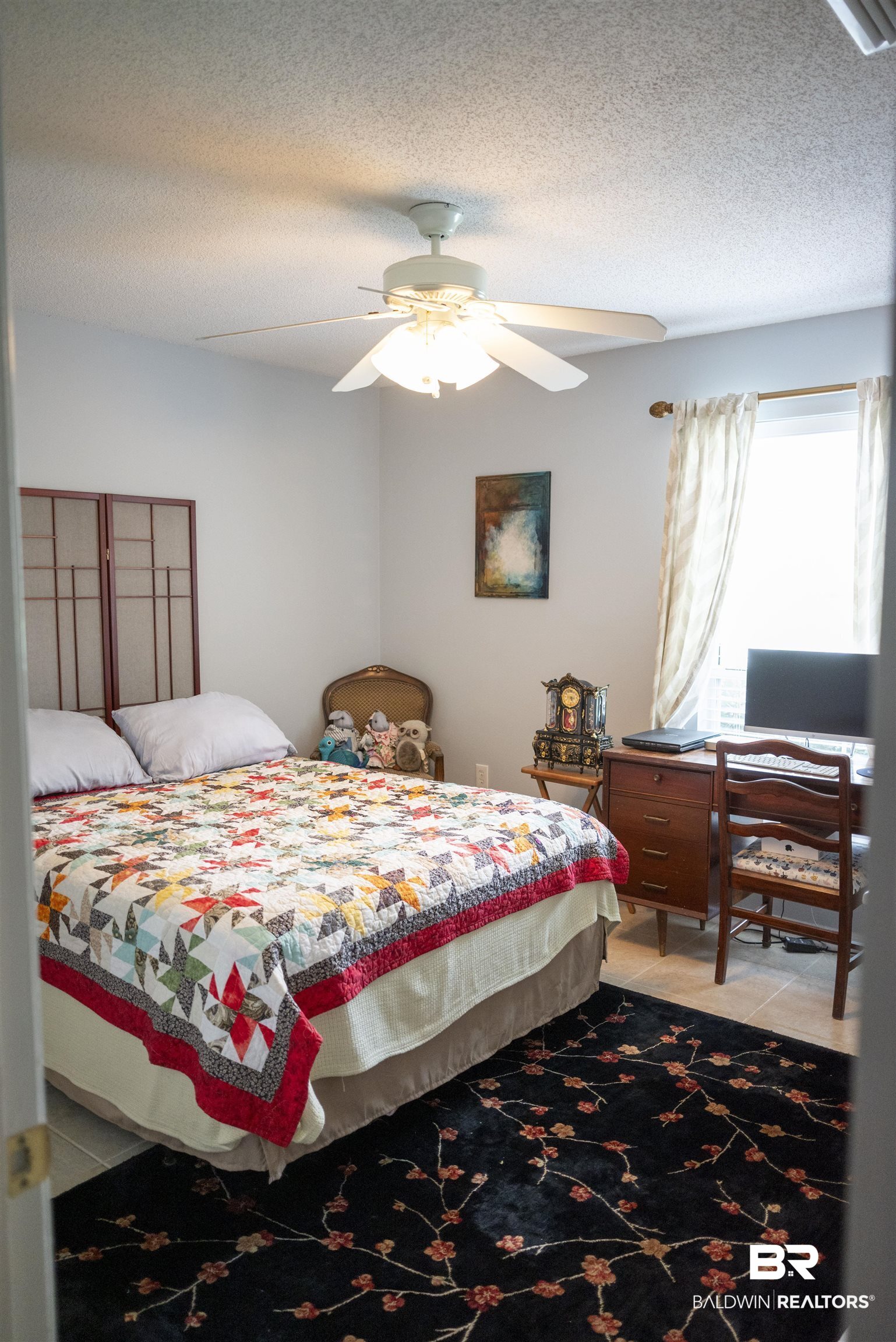 808 Wisteria Lane Foley, AL 36535 - Photo 14 of 19 Bedroom featuring ceiling fan and a textured ceiling