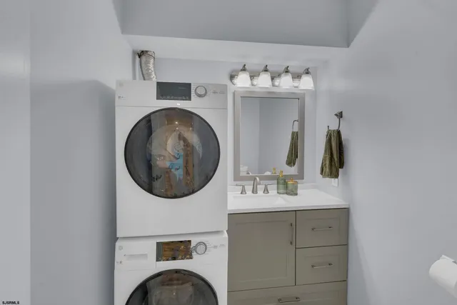 a bathroom with a sink vanity mirror and tub