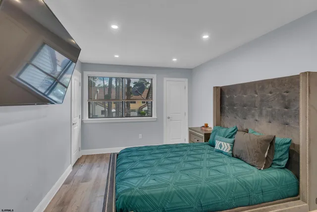 a bed sitting in a bedroom next to a window