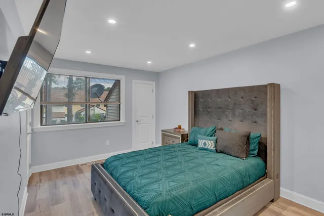 a bed sitting in a bedroom next to a window