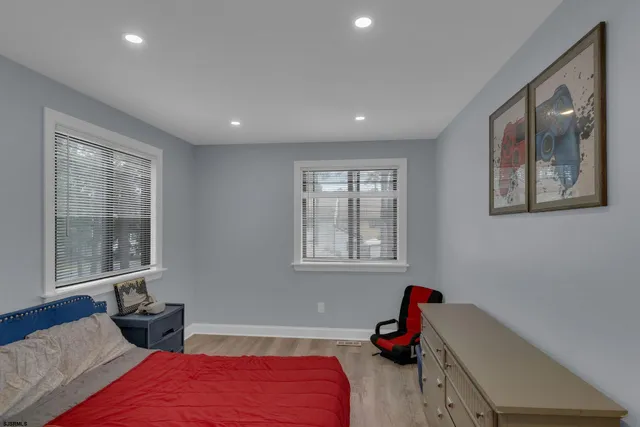 a bedroom with two beds and a window