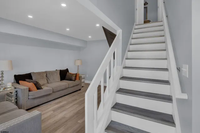 a living room with furniture and stairs
