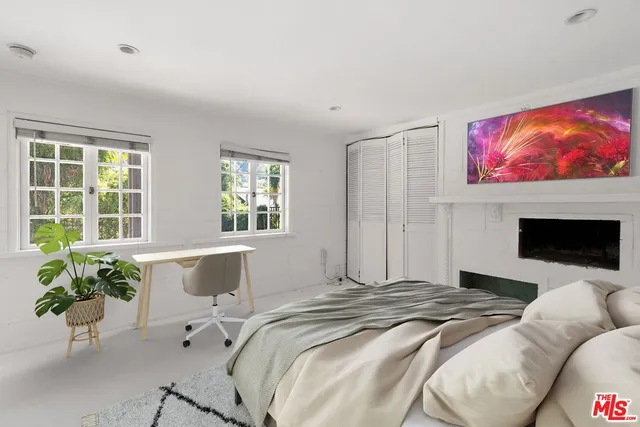 a bedroom with a bed and glass windows