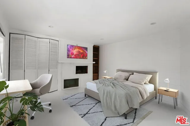 a spacious bedroom with a bed and a couch