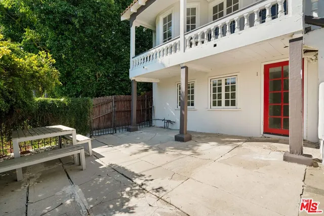 a backyard of a house with barbeque oven and outdoor seating