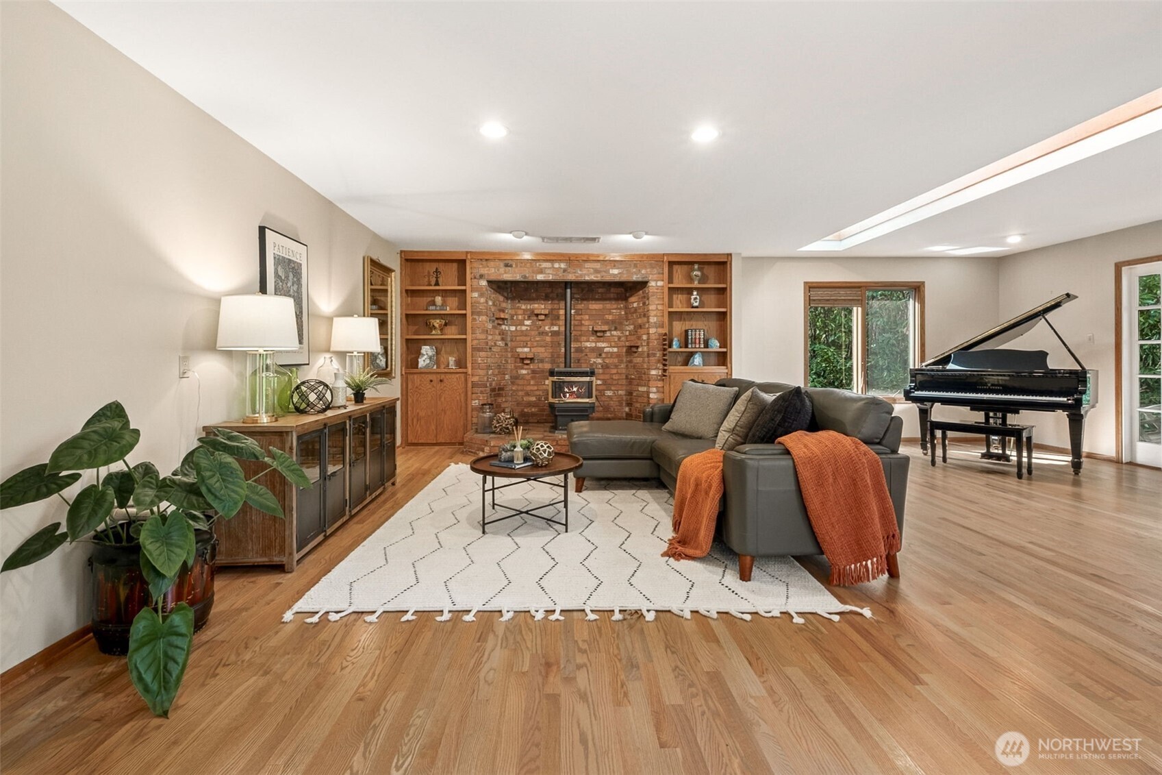 21720 Southeast 246th Street Maple Valley, WA 98038 - Photo 13 of 38 a living room with furniture rug and wooden floor