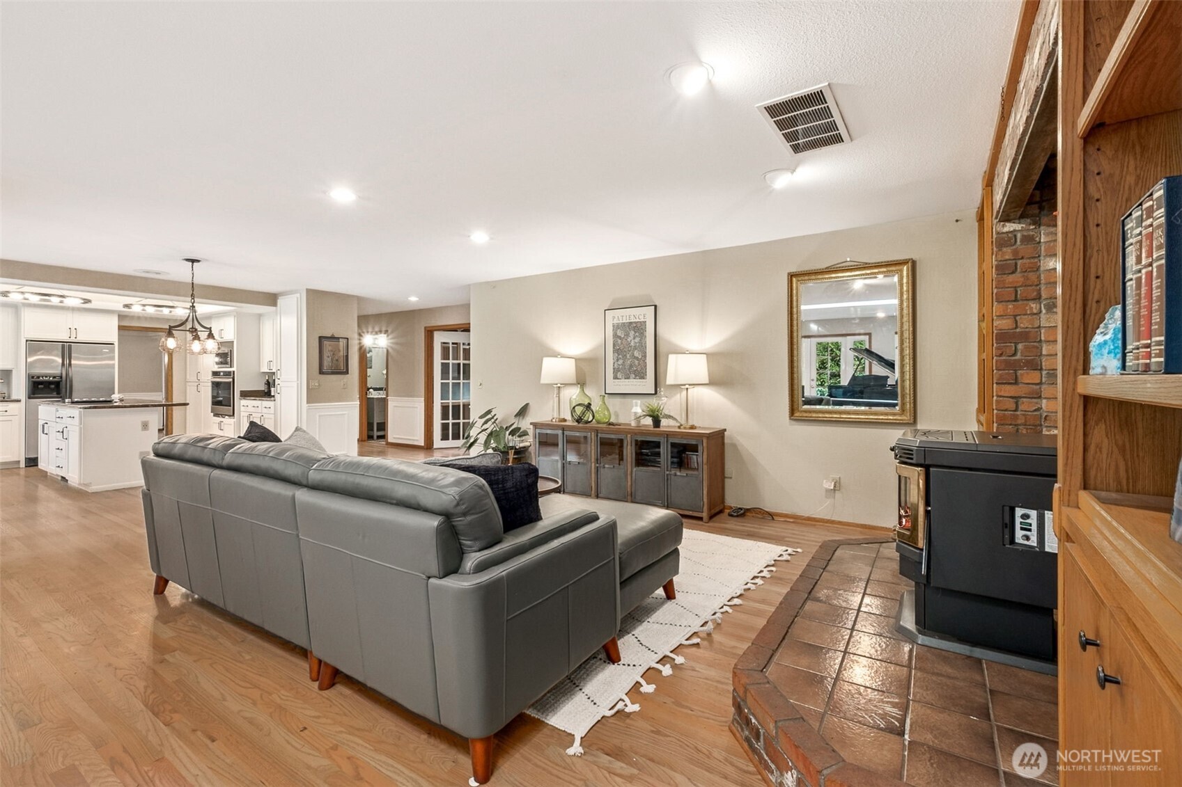 21720 Southeast 246th Street Maple Valley, WA 98038 - Photo 17 of 38 a living room with furniture and a flat screen tv